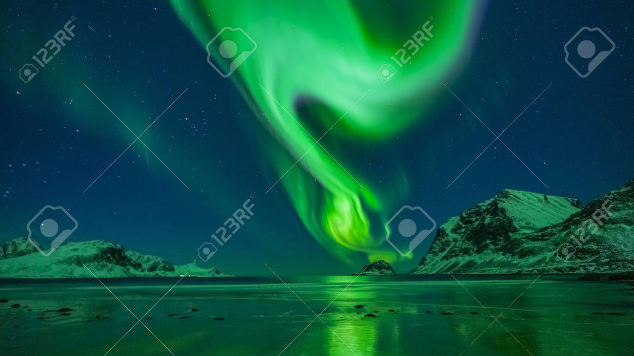 amazing clear night sky with aurora borealis over a beach with reflections, lofoten, norway - 132456340 amazing clear night sky with aurora borealis over a beach with reflections, lofoten, norway - 132456340