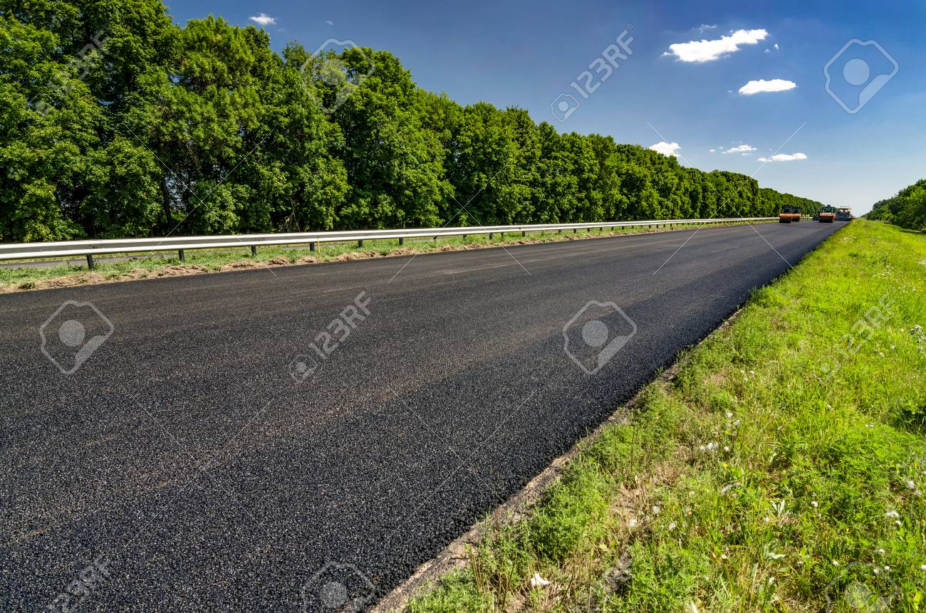 road roller rolls freshly laid asphalt road construction stock laid asphalt