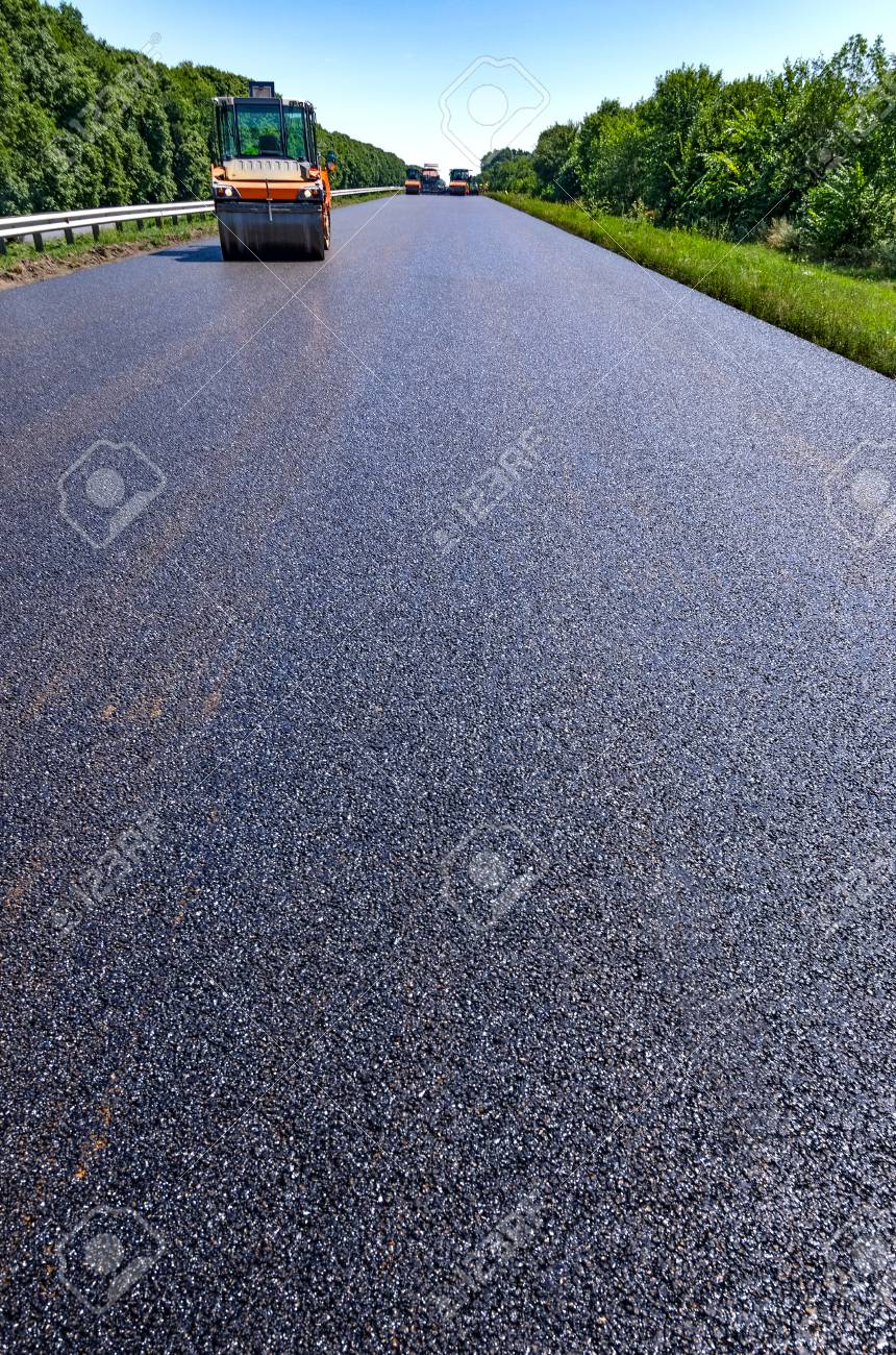 road roller rolls freshly laid asphalt stock photo picture and laid asphalt