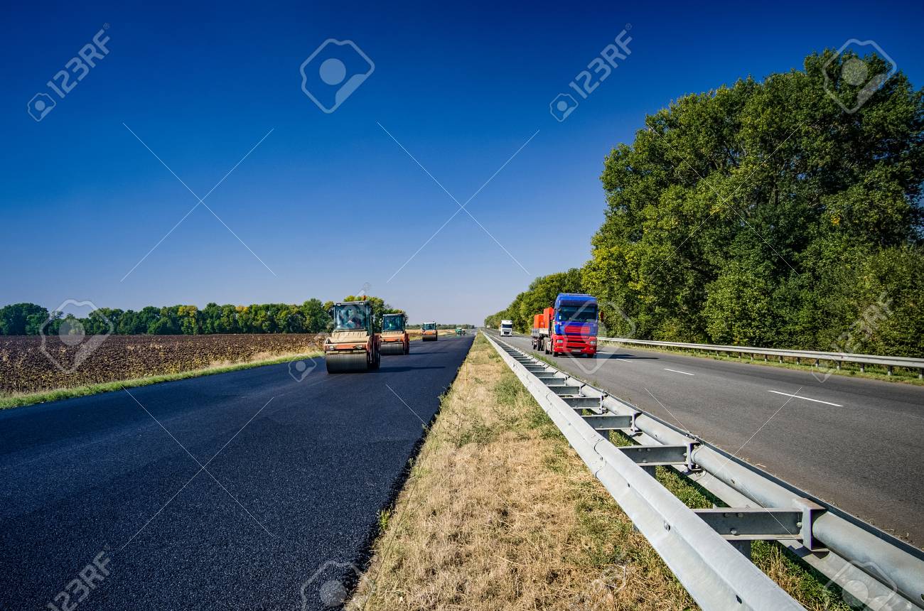 road roller rolls freshly laid asphalt road construction stock laid asphalt
