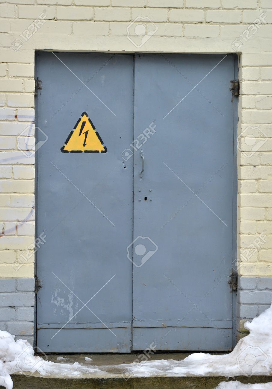 Rusty Metal Door danger high voltage sign on a rusty metal door stock photo Rusty Metal Door danger high voltage sign on a rusty metal door stock photo