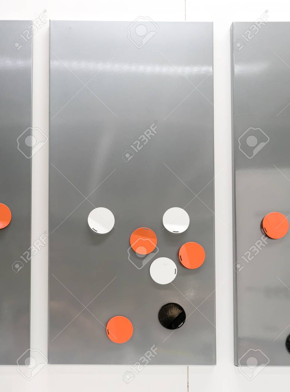 modern colored magnets in round shape on empty metal grey magnetic