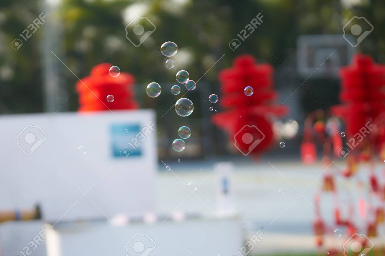 bubbles float or fly in the air with blur background outdoors bubbles float