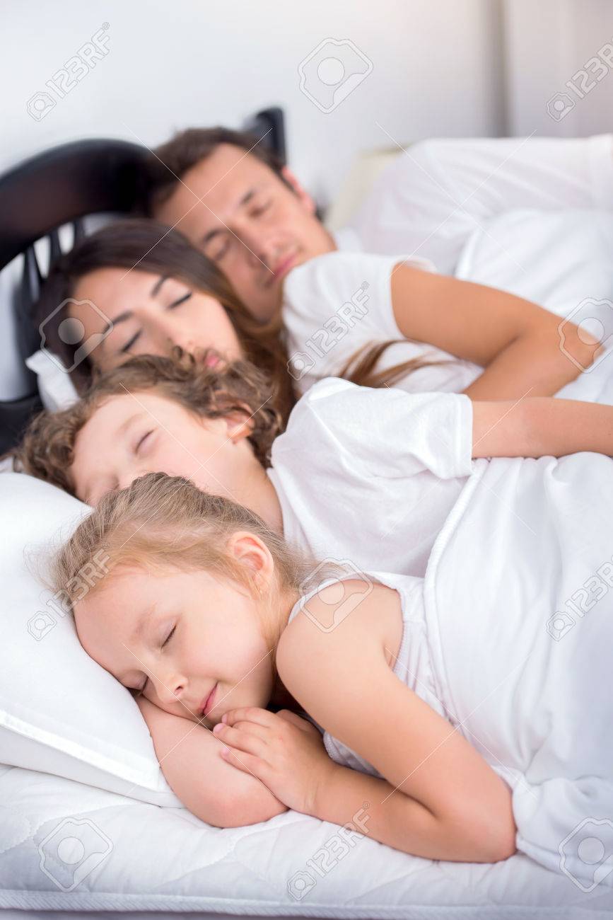 Young Family Of Dad Mom Little Boy And Little Girl Sleeping