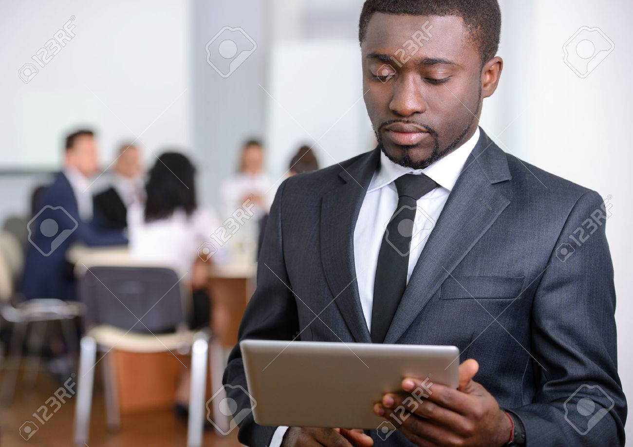 Portrait Of Black Businessman, People Group In Background At Modern Bright  Office Indoors Stock Photo, Picture and Royalty Free Image. Image 32387949., image size:1300x918