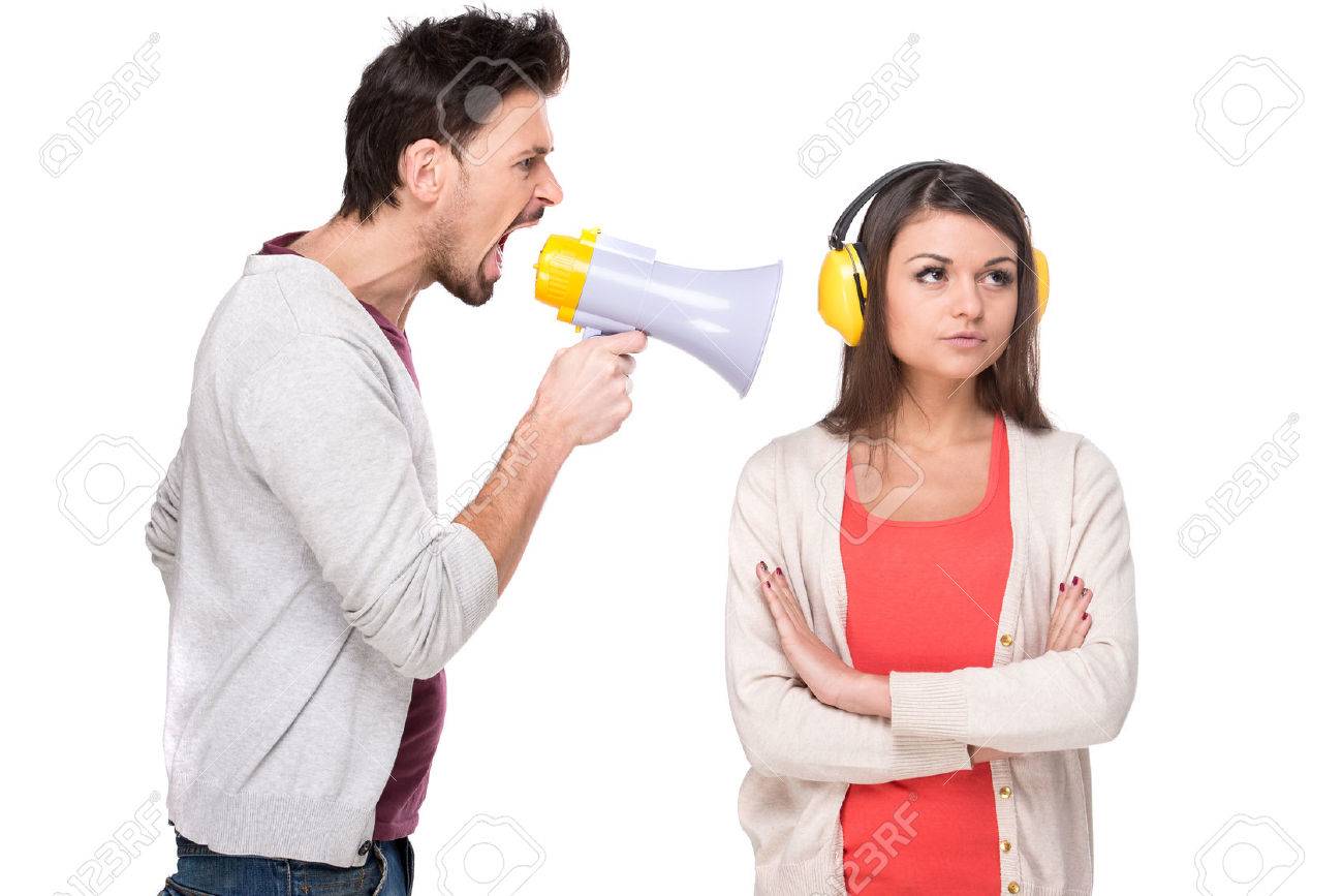 Young Man Shouts At The Woman In A Megaphone Woman With Headphones Stock Photo Picture And Royalty Free Image Image 34485094