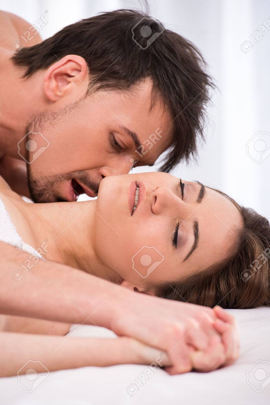 Young Love Couple In Bed Romantic Scene In Bedroom