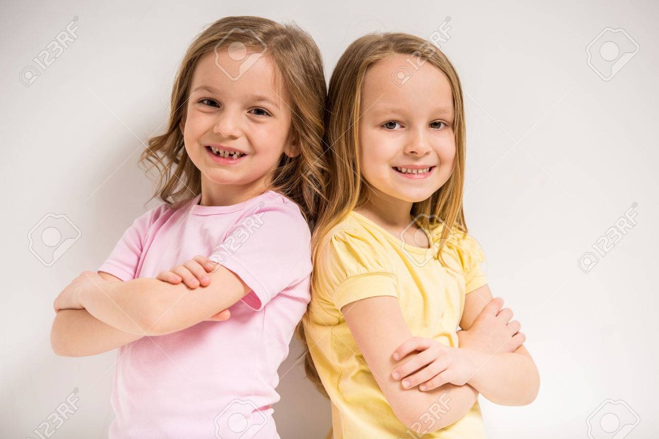 Best Friends Two Cute Little Girls Having A Fun On Grey Background Stock Photo Best Friends Two Cute Little Girls Having A Fun On Grey Background Stock Photo