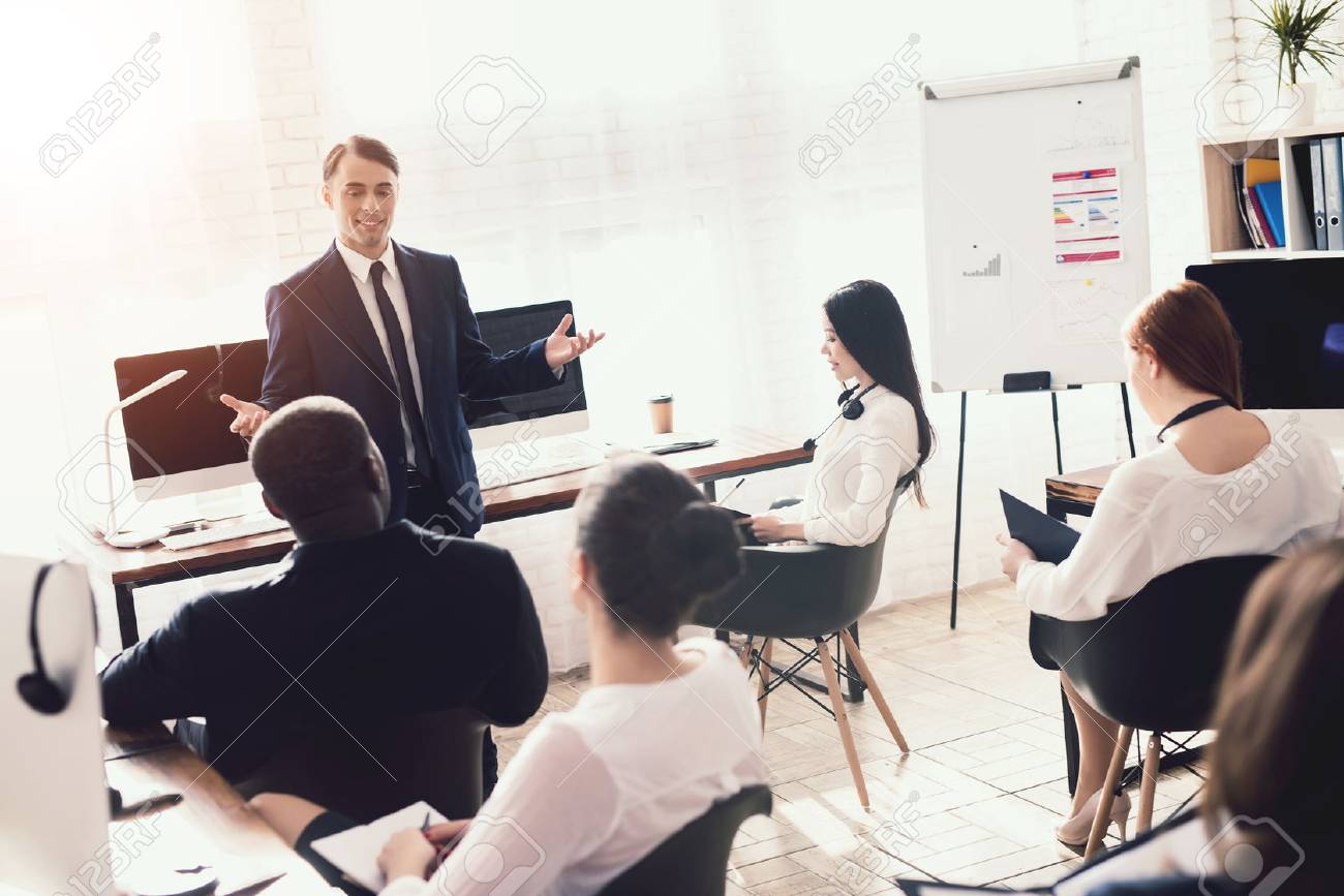 A man of Arabian appearance is giving a lecture for office workers. They have a conference. A man motivates his colleagues. - 96749374 A man of Arabian appearance is giving a lecture for office workers. They have a conference. A man motivates his colleagues. - 96749374