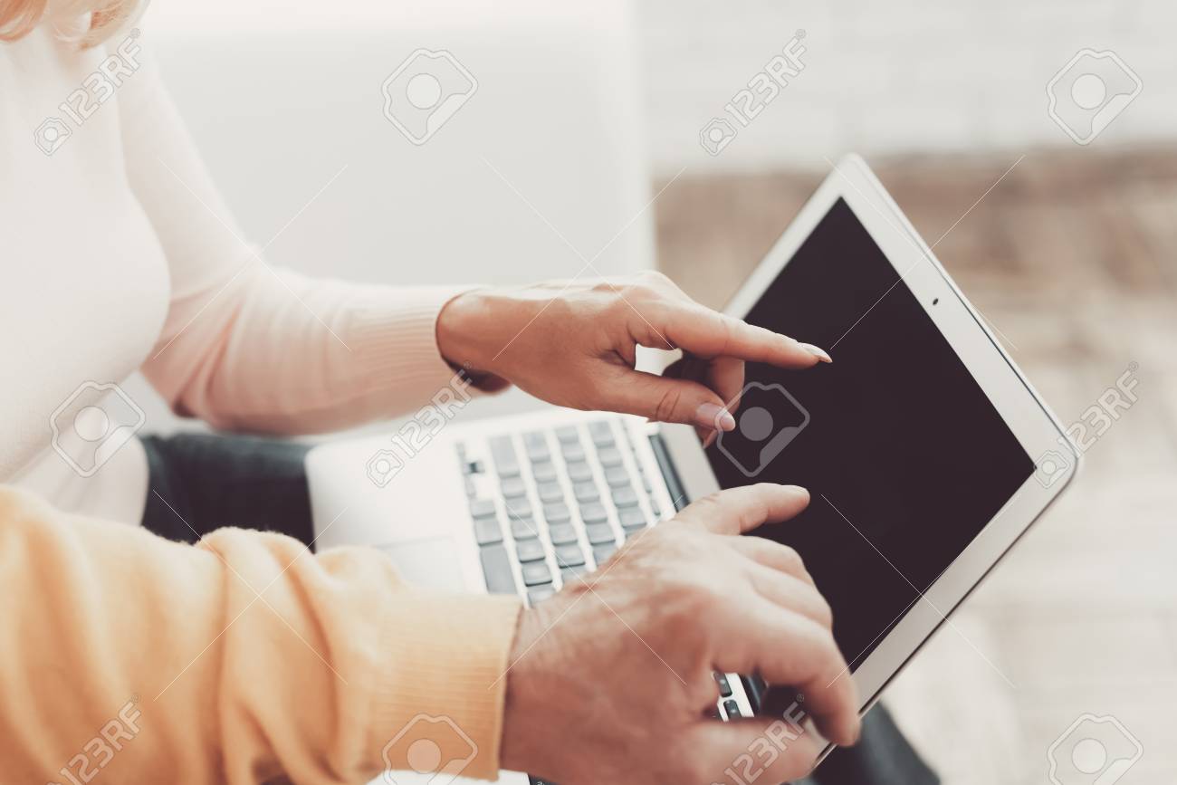 Old Man near Old Woman with Smartphone and Laptop. Sitting on White Sofa. Woman with Laptop. Grandfather and Grandmother. Family at Home. Using Digital Gadget. Holding Cell Phone in Hands. - 108124487 Old Man near Old Woman with Smartphone and Laptop. Sitting on White Sofa. Woman with Laptop. Grandfather and Grandmother. Family at Home. Using Digital Gadget. Holding Cell Phone in Hands. - 108124487