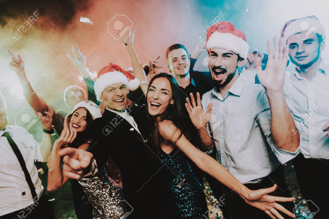 People in Santa Claus Cap Celebrating New Year. Happy New Year. People Have Fun. Indoor Party. Celebrating of New Year. Young Woman in Dress. Young Man in Suit. Happy People. Red Cap. - 109914217 People in Santa Claus Cap Celebrating New Year. Happy New Year. People Have Fun. Indoor Party. Celebrating of New Year. Young Woman in Dress. Young Man in Suit. Happy People. Red Cap. - 109914217