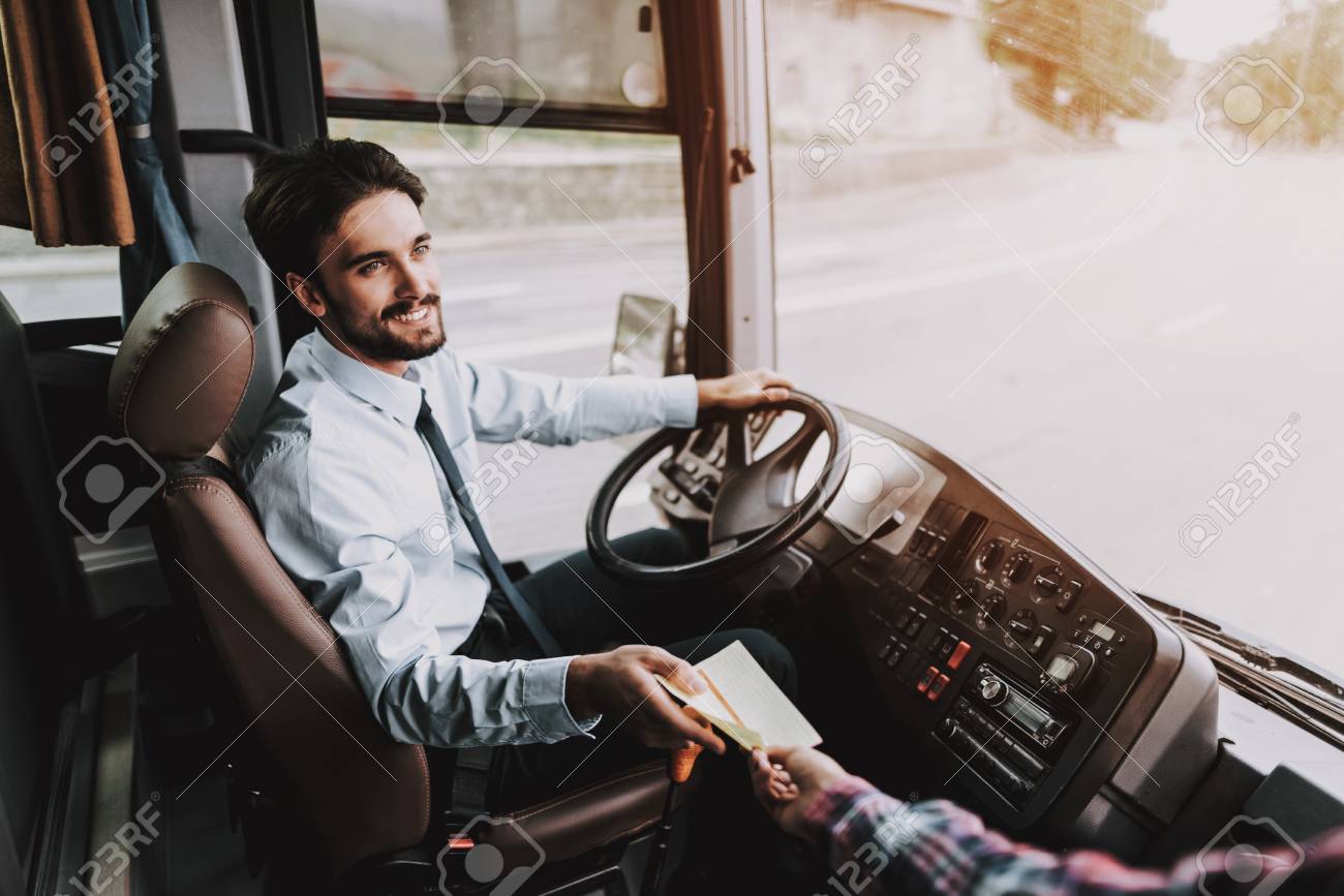 Smiling Young Driver taking Ticket from Passenger. Handsome Happy Man wearing Blue Shirt Sitting on Driver Seat of Tour Bus. Attractive Confident Man at Work. Traveling, Transport and Tourism Concept - 111177421 Smiling Young Driver taking Ticket from Passenger. Handsome Happy Man wearing Blue Shirt Sitting on Driver Seat of Tour Bus. Attractive Confident Man at Work. Traveling, Transport and Tourism Concept - 111177421