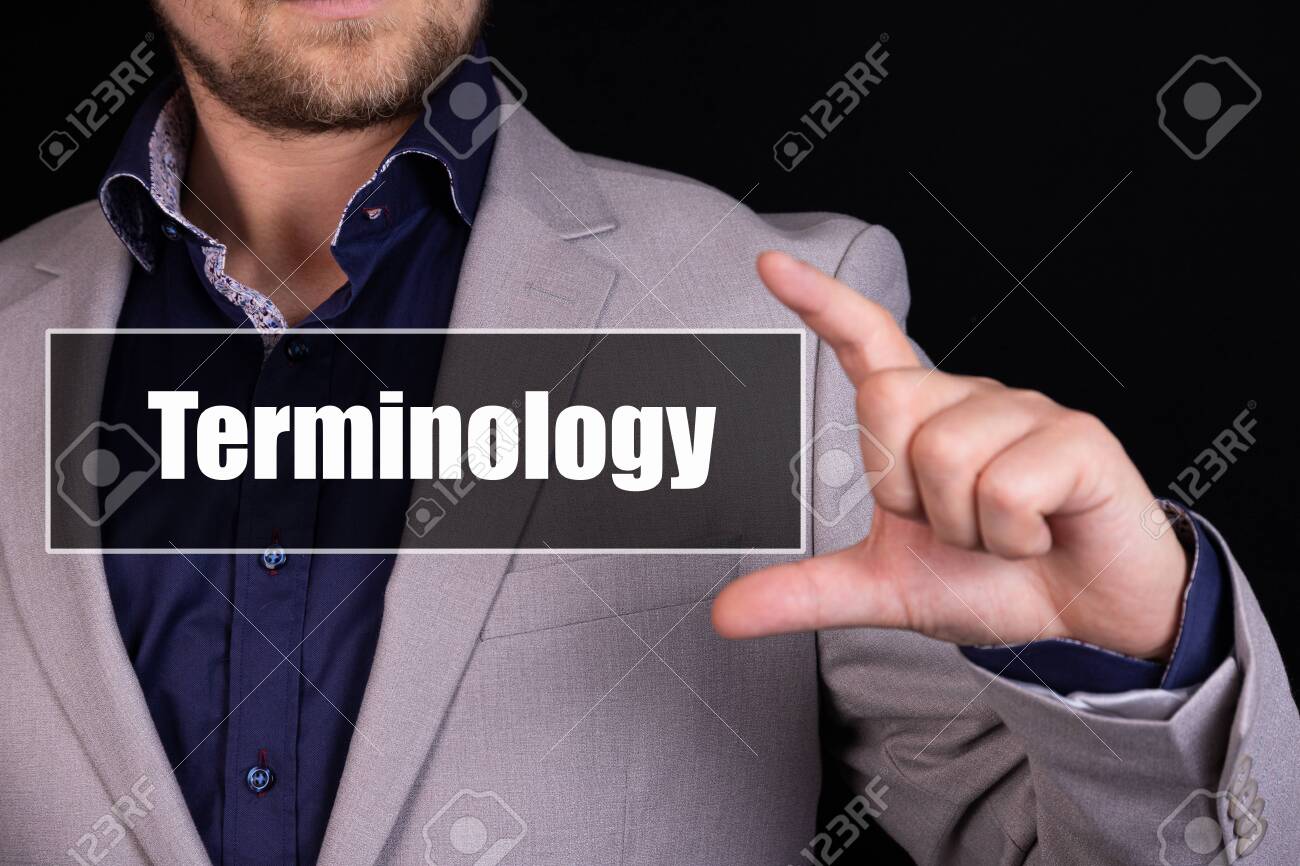 Businessman on a black background holds an icon with the text Terminology - 148396634 Businessman on a black background holds an icon with the text Terminology - 148396634