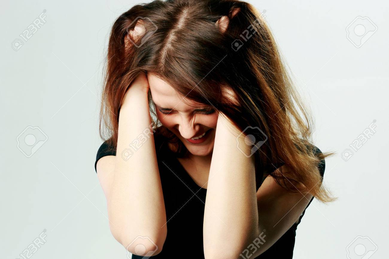 Portrait Of A Frustrated Young Screaming Woman Pulling Her Hair On Gray  Stock Photo, Picture and Royalty Free Image. Image 25225495., image size:1300x866