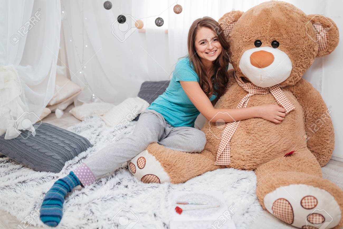 Pretty Smiling Girl Sitting And Hugging Big Plush Bear At Home Stock Photo Picture And Royalty Free Image Image