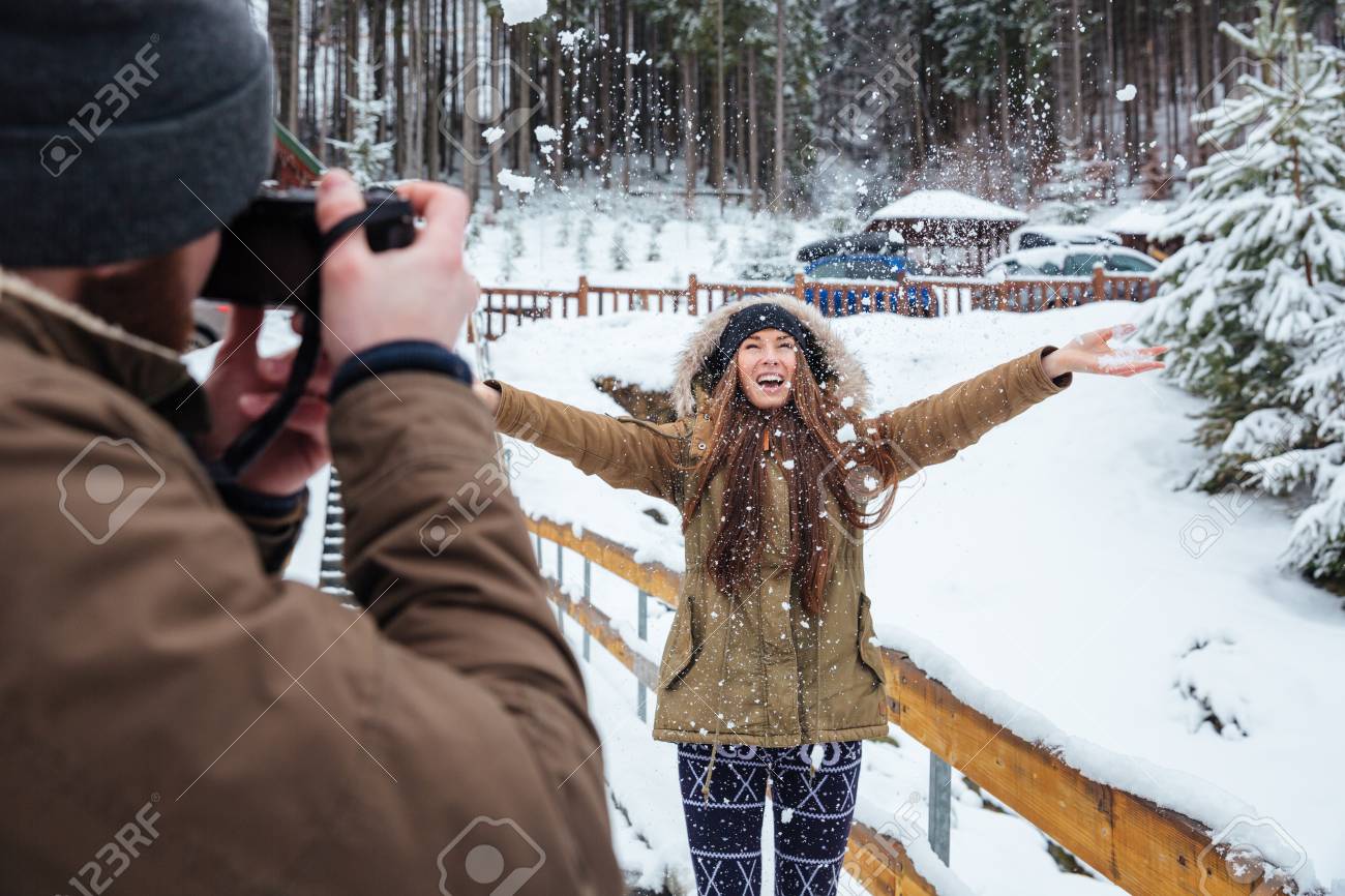 Fotógrafo De Sexo Masculino De Tomar Imágenes De Feliz Mujer Excitada Joven  Lanza Para Arriba Nieve En Bosque Del Invierno Fotos, retratos, imágenes y  fotografía de archivo libres de derecho. Image 54412320