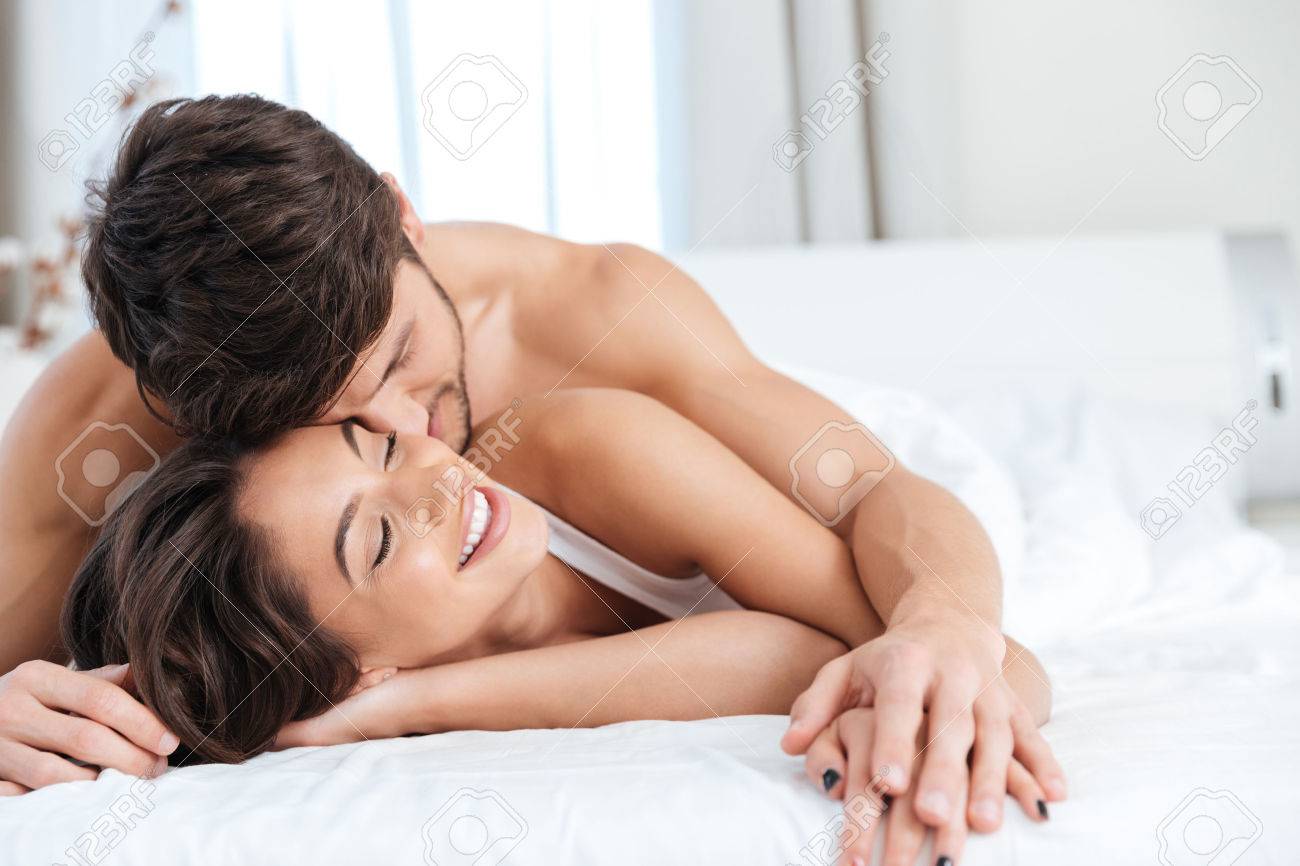 Young Lovely Couple In Love On The Bed In Bedroom Stock Photo, Picture And  Royalty Free Image. Image 58451197.