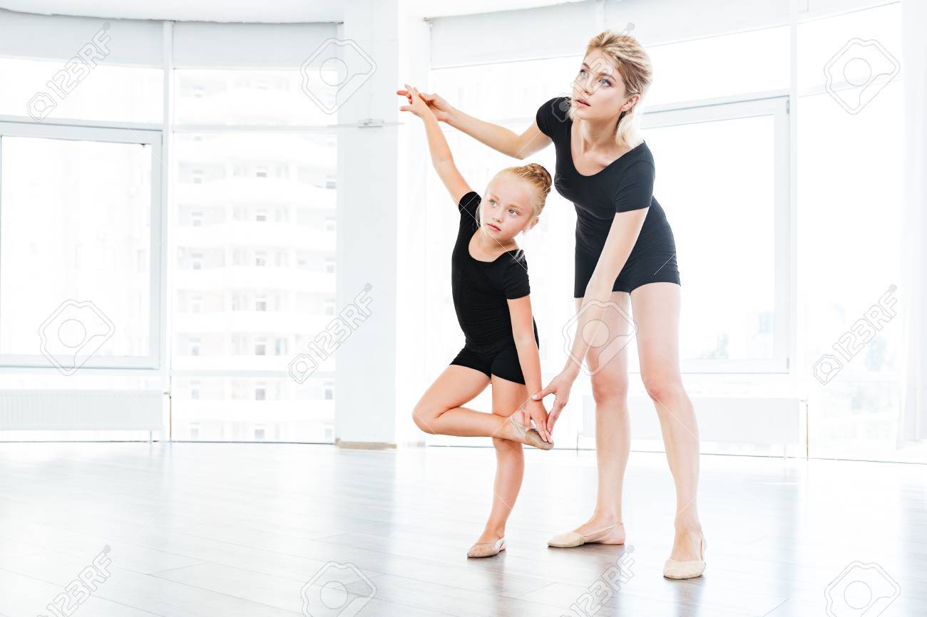 young little girl ballerina learning dance lesson with female