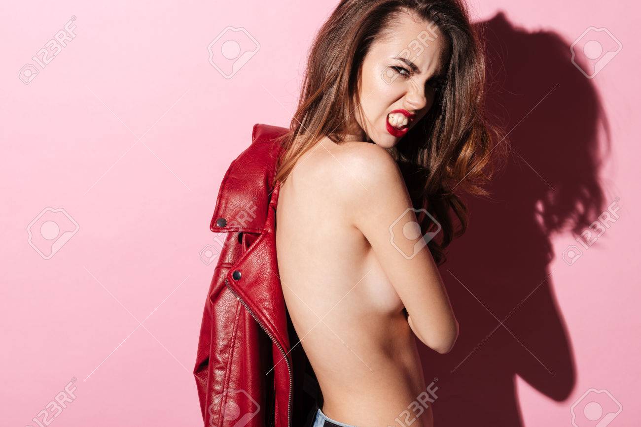 Portrait Of A Beautiful Angry Naked Girl Posing And Holding Leather Jacket  Over Pink Background Stock Photo, Picture and Royalty Free Image. Image  79834787.