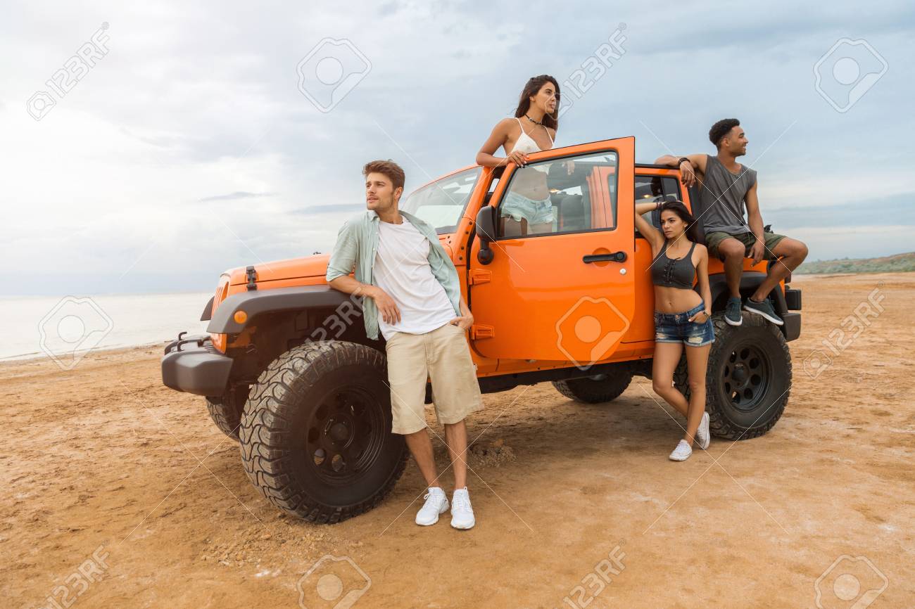 picture Standing Pose For Boys With Car group of young cheerful people standing near their car and posing