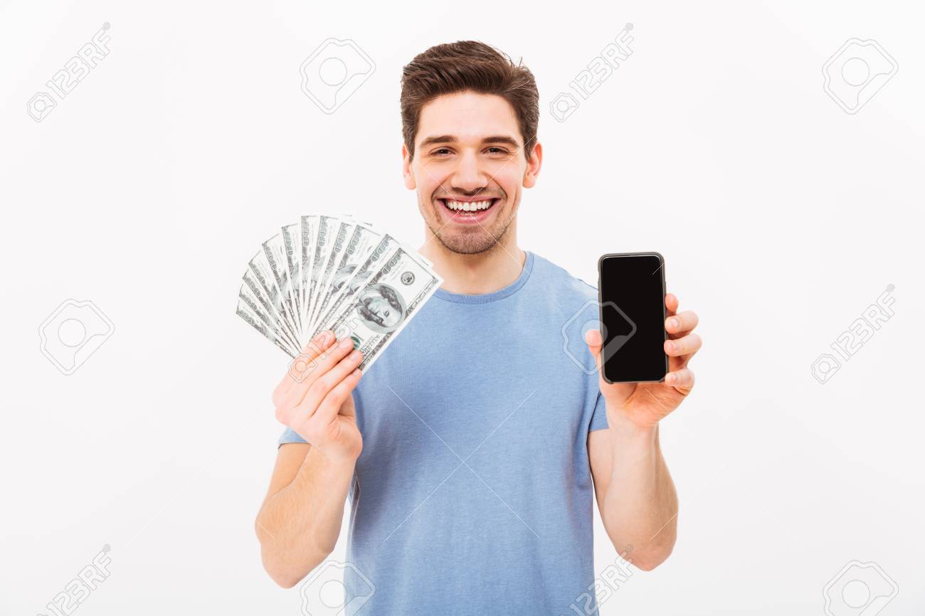 Photo Of Happy Man In Casual T Shirt Holding Fan Of Money In - 