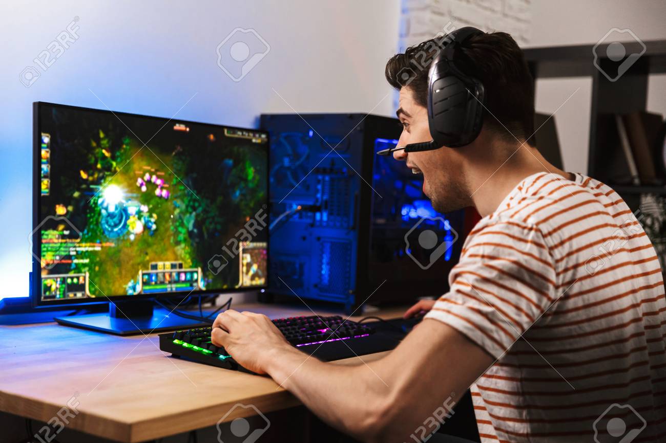 https://previews.123rf.com/images/vadymvdrobot/vadymvdrobot1809/vadymvdrobot180904677/108841008-portrait-of-happy-gamer-guy-in-headphones-rejoicing-while-playing-video-games-on-computer.jpg
