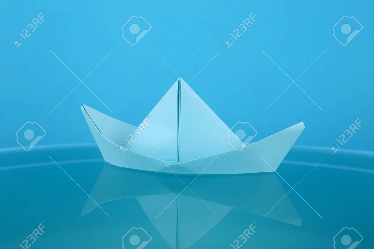 Blue Paper Boat Origami Paper Ship Sailing On Blue Water Surface Stock Photo Picture And Royalty Free Image Image 75531473