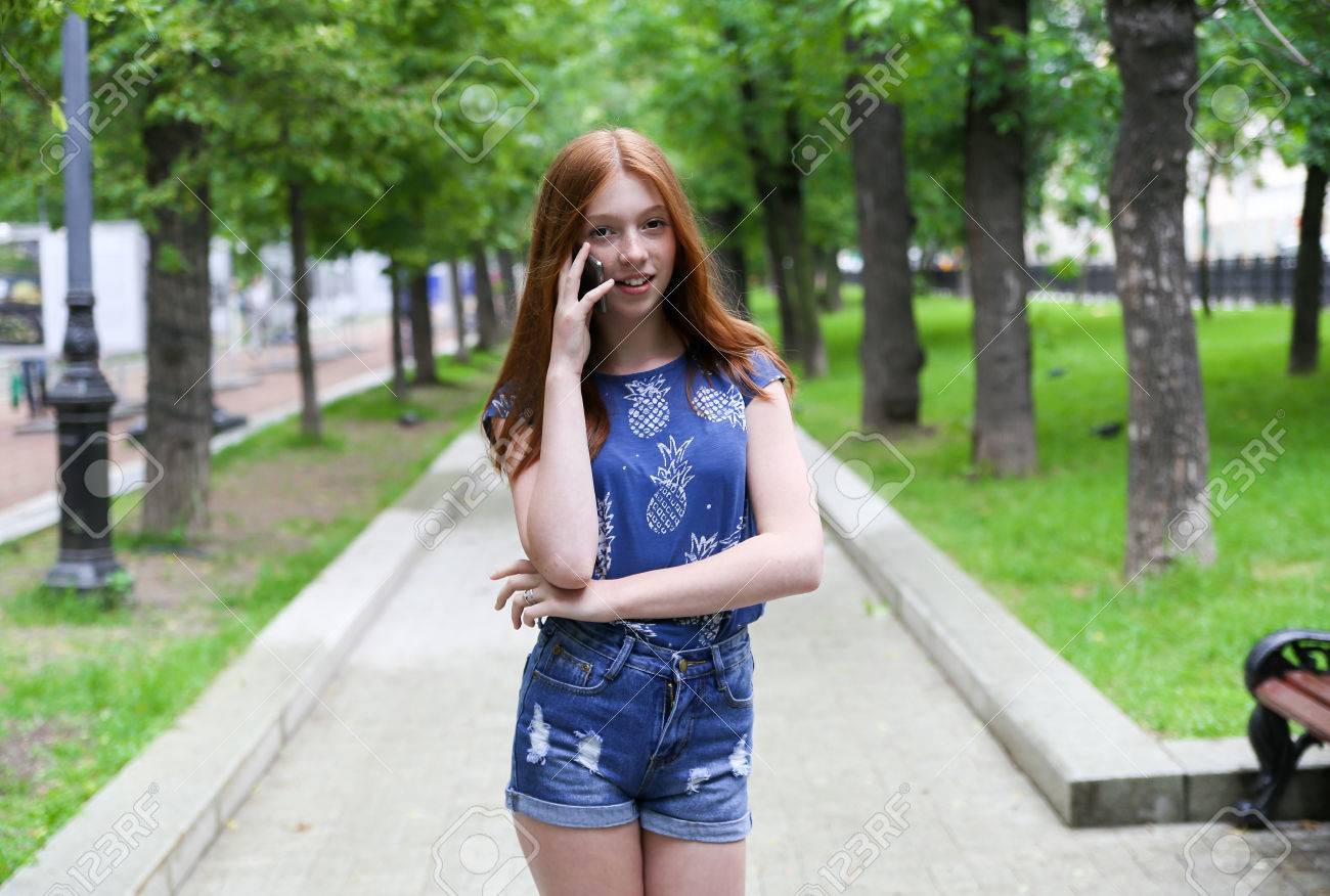 Beautiful And Slender Teen Girl Is In The Park And Talking On The Phone Young Beautiful And Slender Teen Girl Is In The Park And Talking On The Phone Young