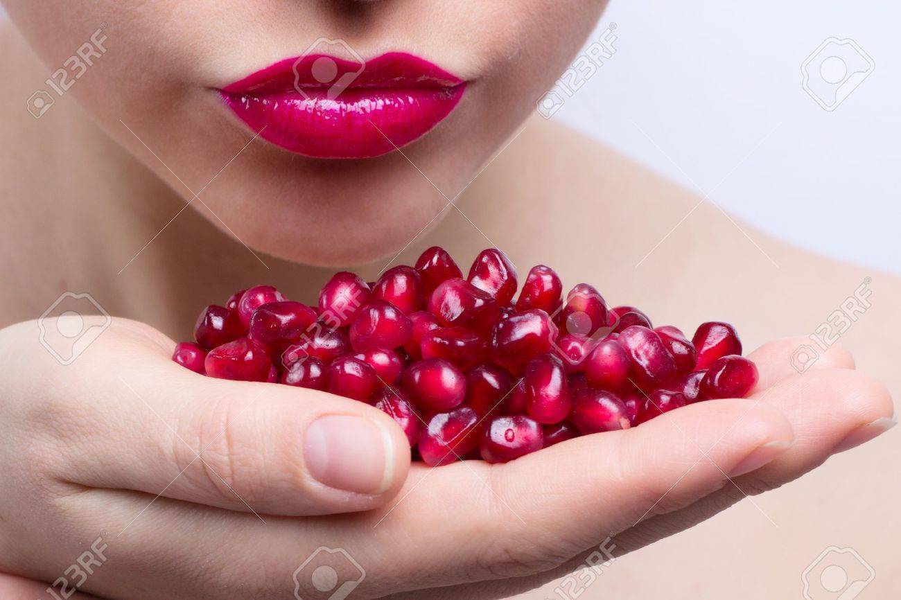 young beautiful woman with seeds of pomegranate - 9284150 young beautiful woman with seeds of pomegranate - 9284150