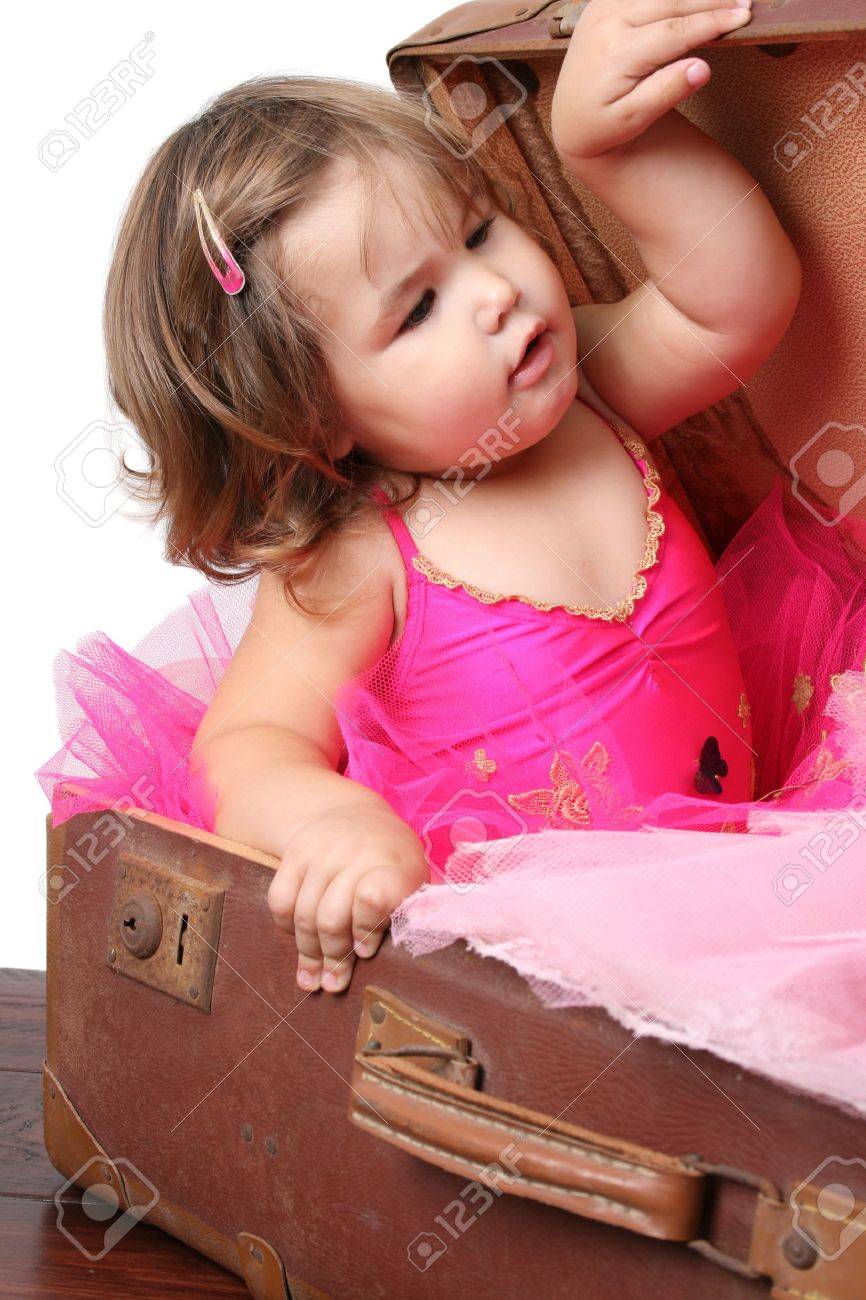 Little Girl With Short Hair Wearing A Bright Pink Ballet Outfit