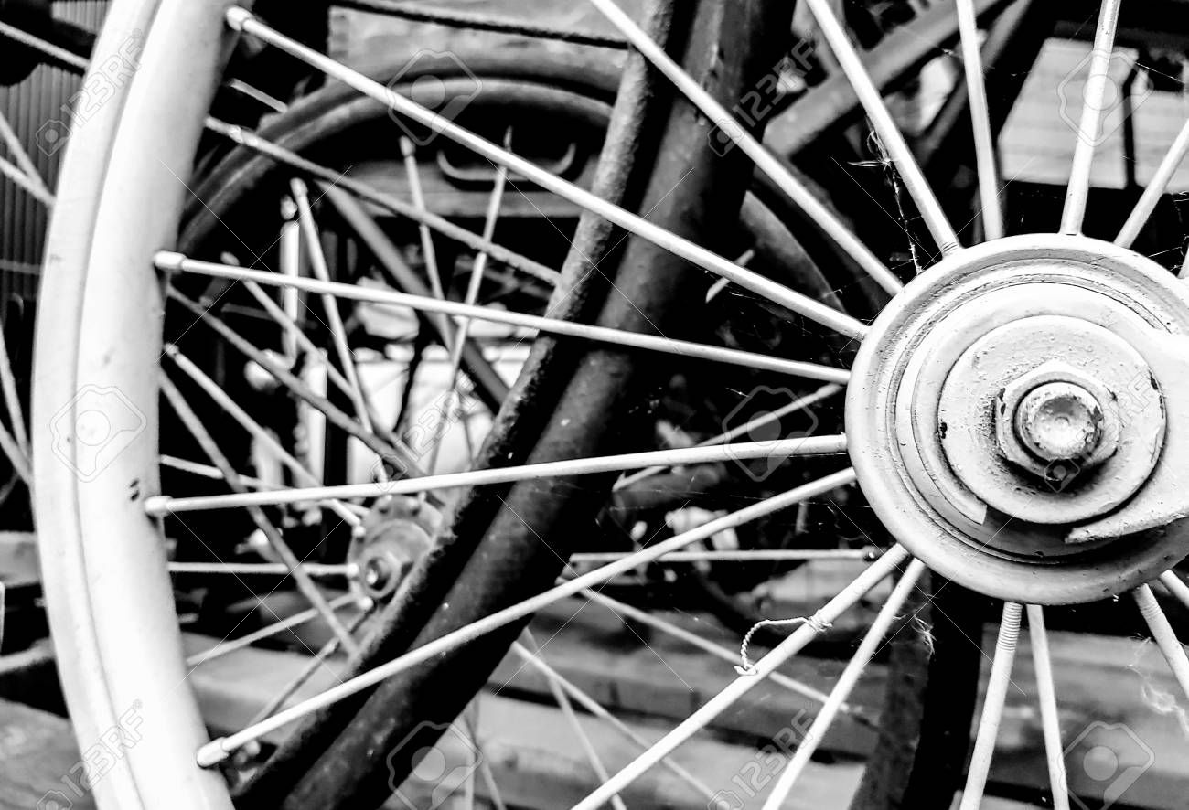 classic old style bicycle close up parked back wheels on black