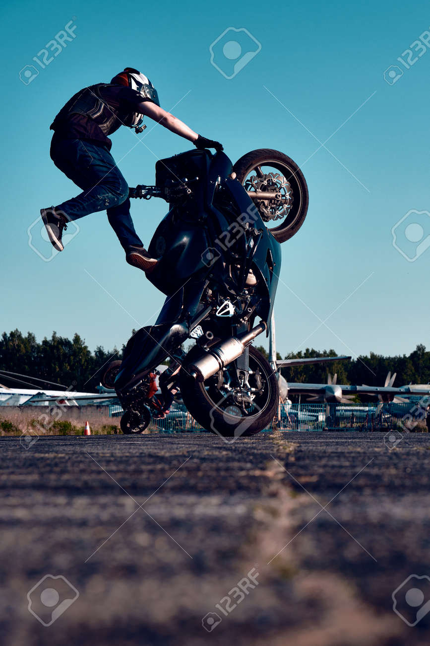 Free Photo  Moto rider making a stunt on his motorbike biker