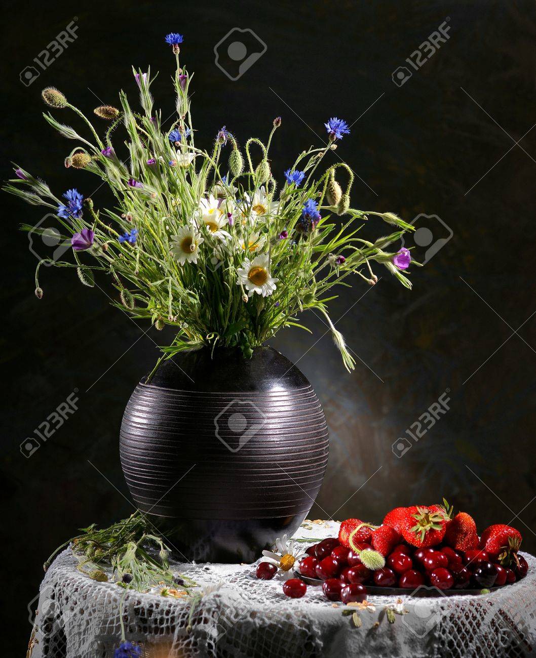 Colorful Flower Arrangement Centerpiece In Black Vase And Fruits