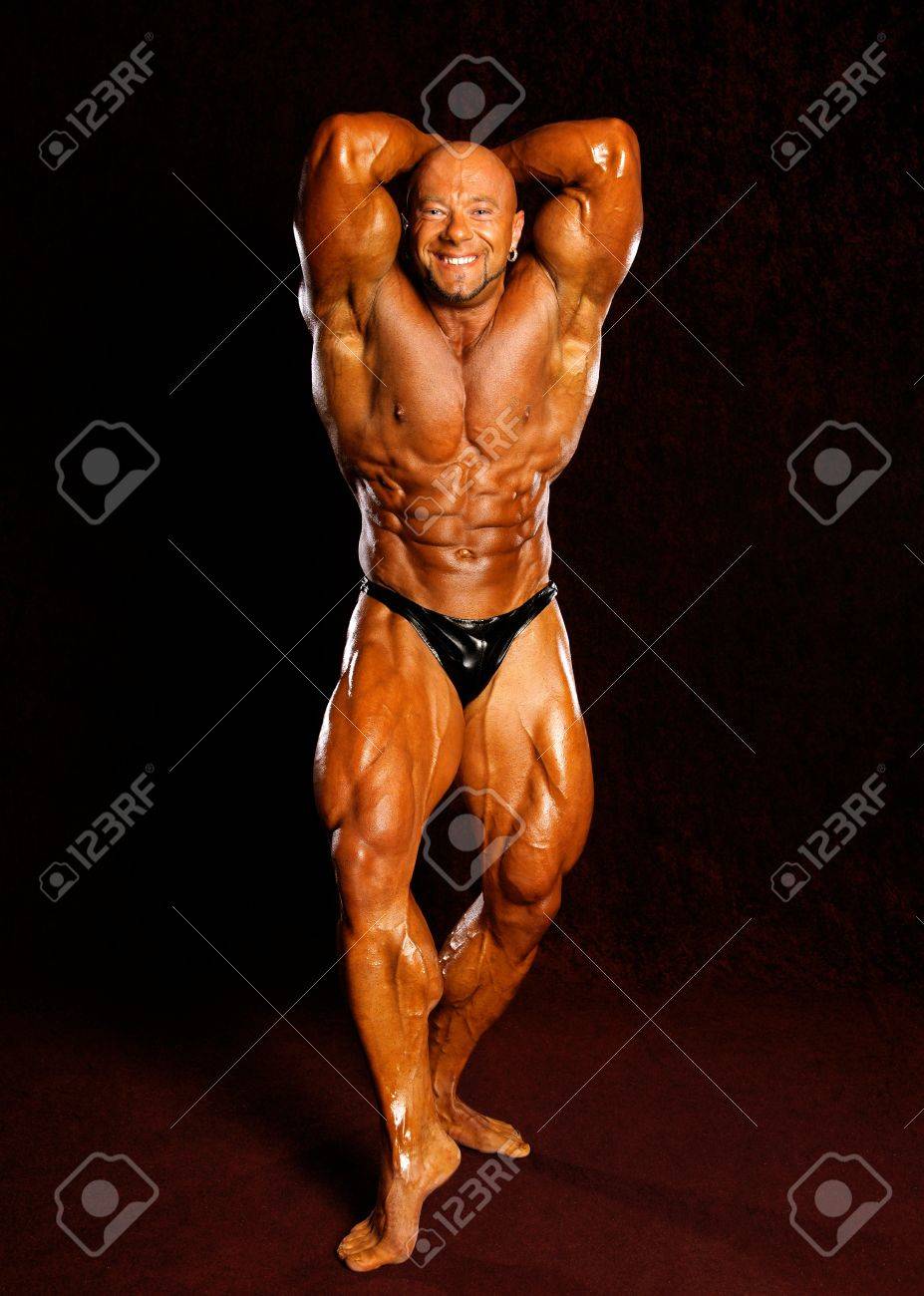 Bodybuilder Posing On A Dark Background Stock Photo Picture And Royalty Free Image Image