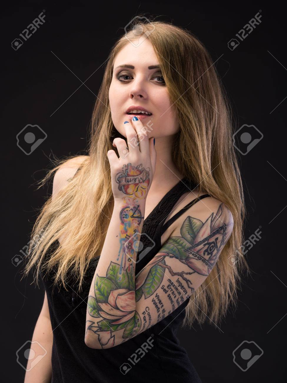 Happy And Smiling Girl Posing On A Dark Background. Hand Of Girl In Tattoos  Stock Photo, Picture and Royalty Free Image. Image 66319882., image size:975x1300