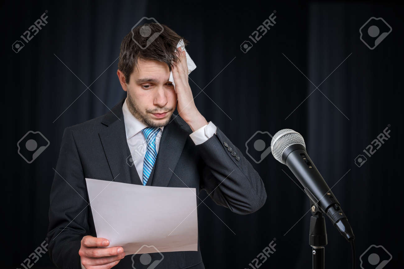 Sweating Nervous Speaker Is Afraid Of Public Speech. Microphone In Front.  Фотография, картинки, изображения и сток-фотография без роялти. Image  157214587