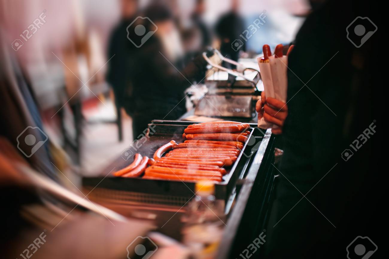 Cooking hot dogs on the street. sausage cooking for hot dog. electric stove for sausage roasting. commercial equipment for cafe and street food. - 116150392 Cooking hot dogs on the street. sausage cooking for hot dog. electric stove for sausage roasting. commercial equipment for cafe and street food. - 116150392