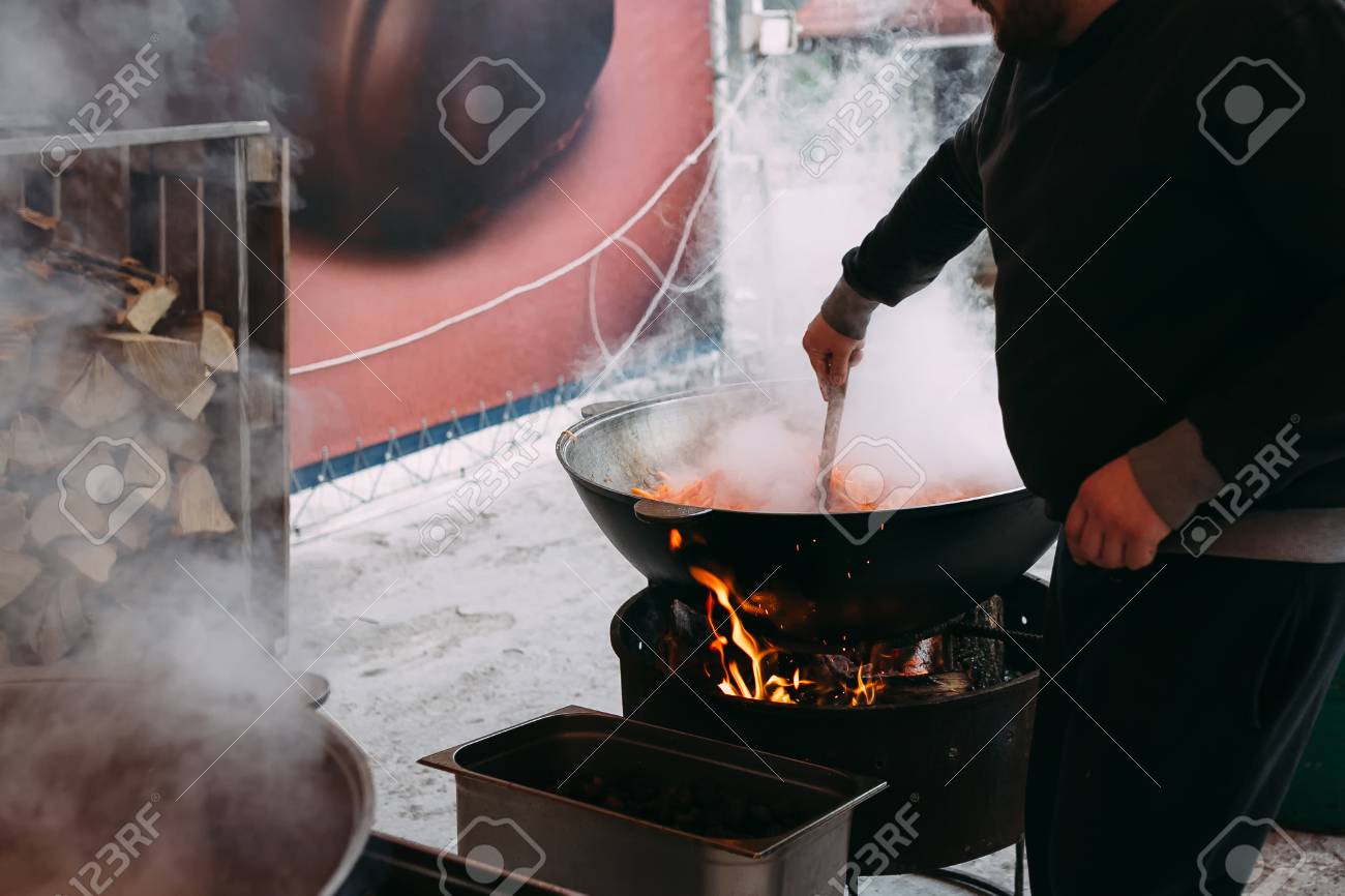 Cook mixes tasty pilaf with his hand - 116150391 Cook mixes tasty pilaf with his hand - 116150391