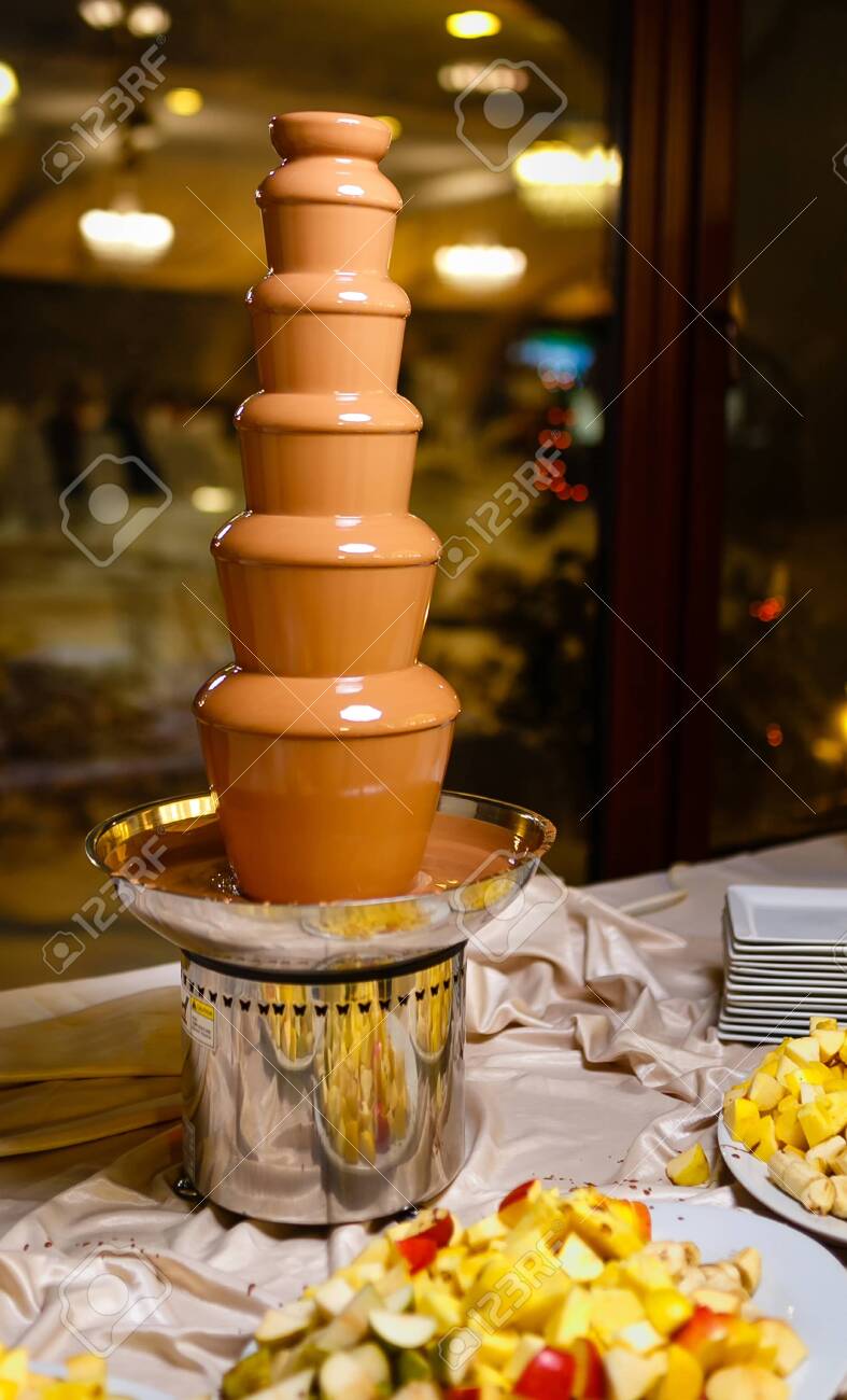 chocolate fondue with pieces apples in restaurant - 118993508 chocolate fondue with pieces apples in restaurant - 118993508