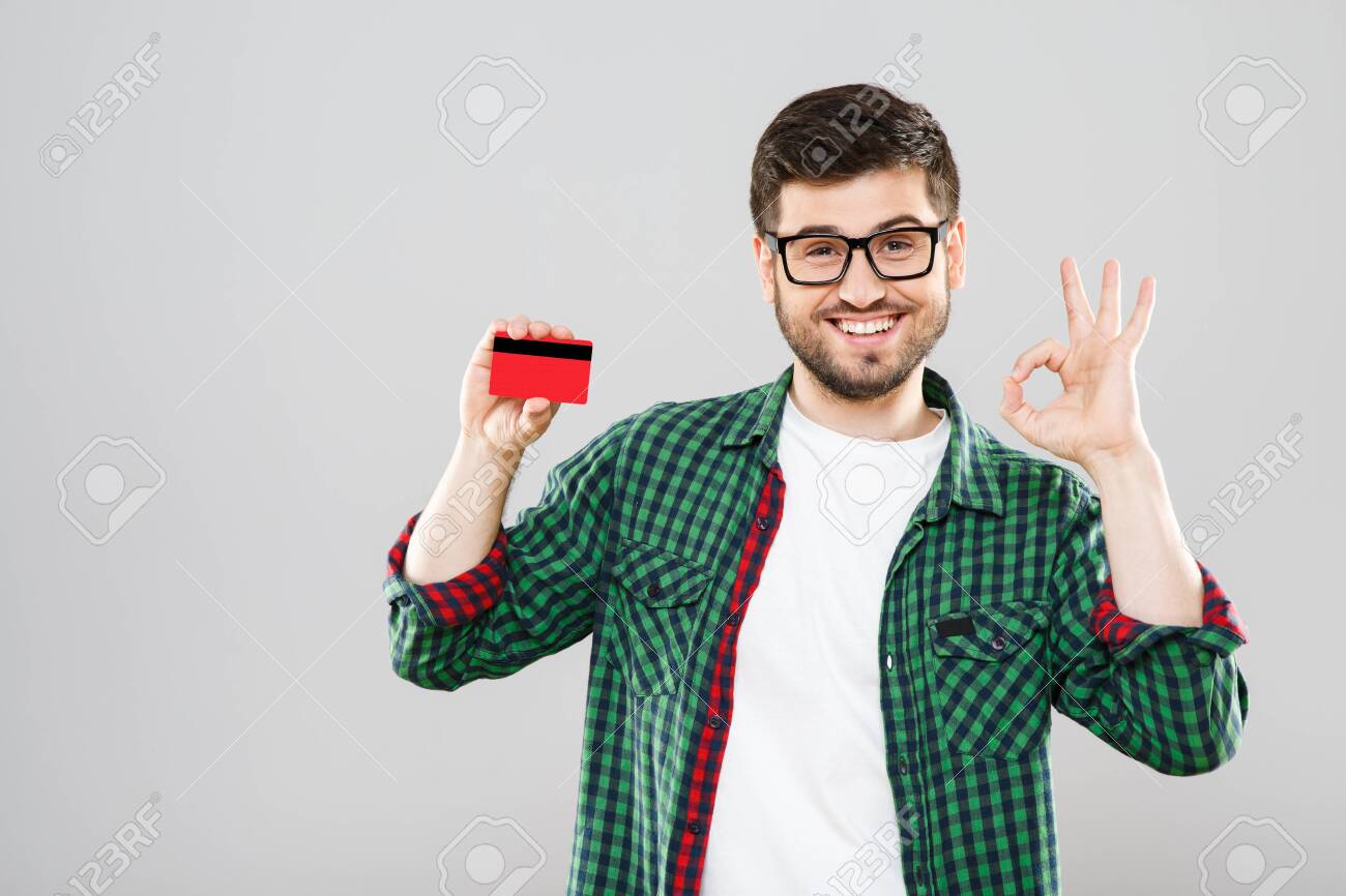 Man holding red credit card and showing ok - 122278759 Man holding red credit card and showing ok - 122278759