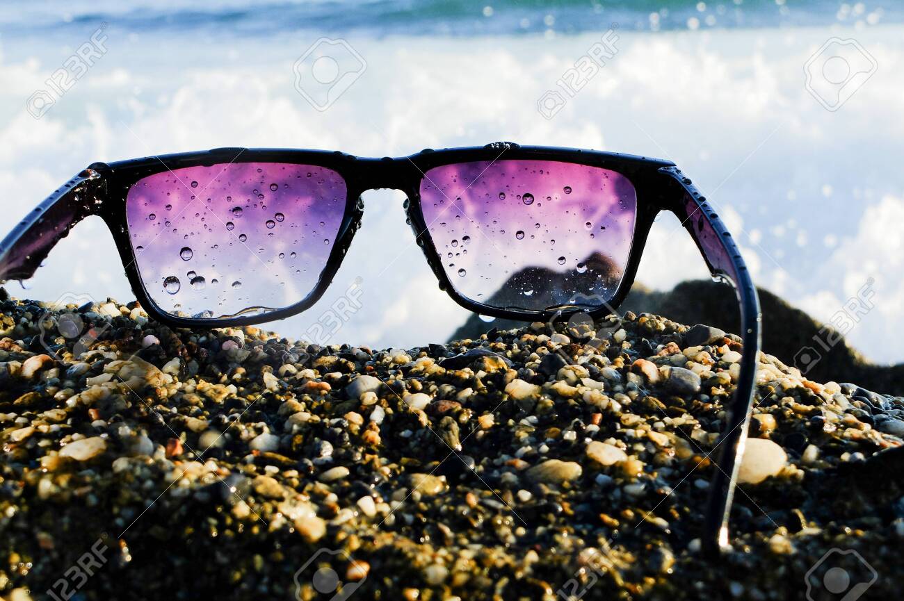 Black sunglasses at sea background - 122488830 Black sunglasses at sea background - 122488830