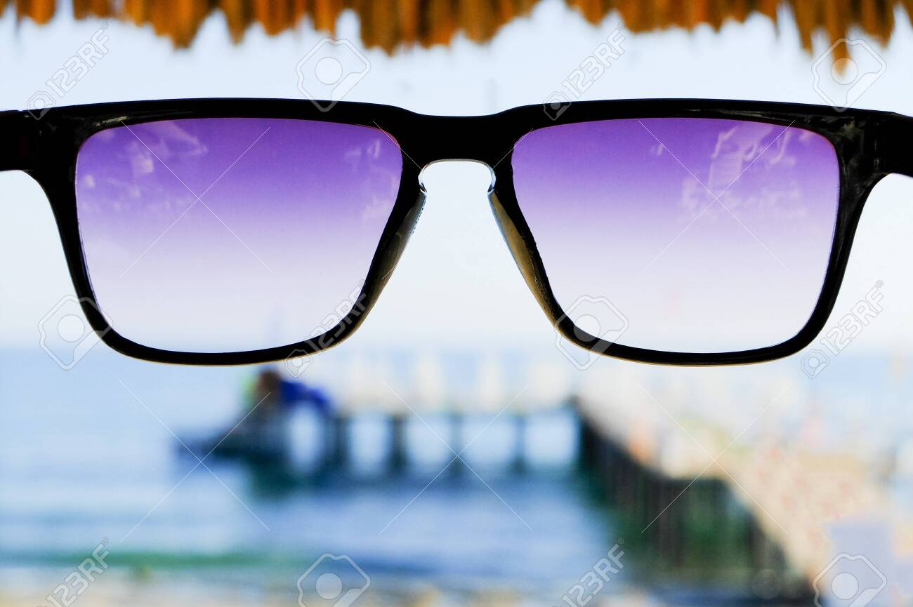 Black sunglasses at sea background - 122488831 Black sunglasses at sea background - 122488831