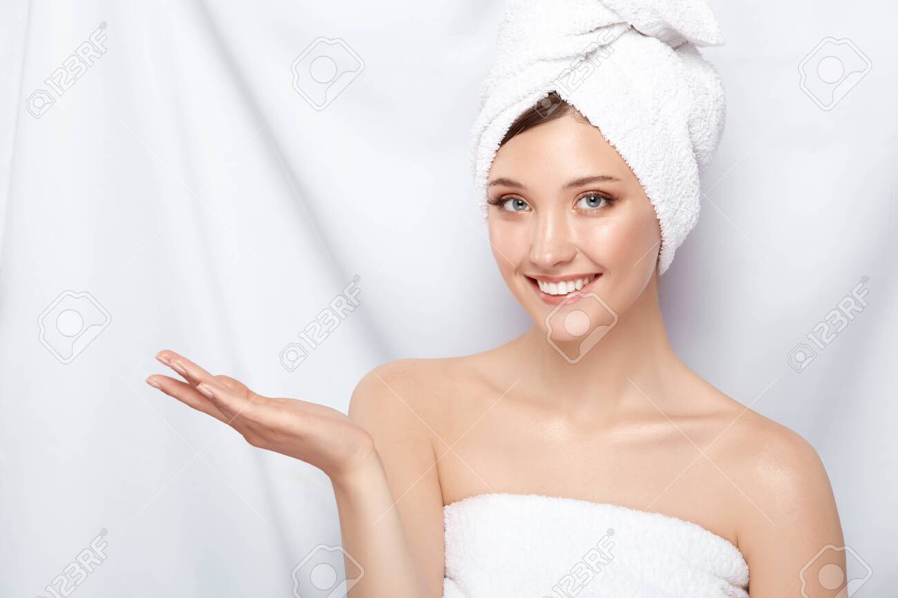 attractive young lady in bath towel on head pretending that she holding something on her arm, copy space, pretty girl keeps arm near shoulder - 123710964 attractive young lady in bath towel on head pretending that she holding something on her arm, copy space, pretty girl keeps arm near shoulder - 123710964