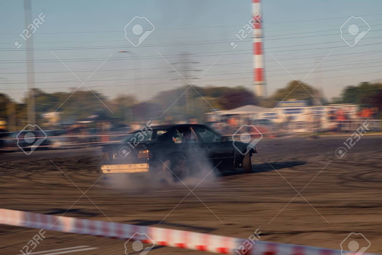 Premium AI Image Car drifting Blurred image diffusion race drift car with lots of smoke from burning tires on track