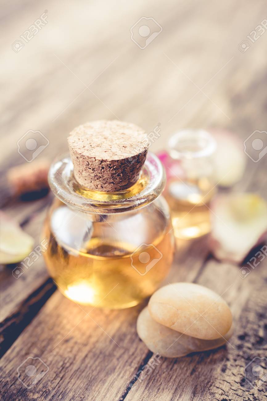 Aromatic Massage Oil And Zen Stones Close Up SPA Background In A Rustic Style Aromatic Massage Oil And Zen Stones Close Up SPA Background In A Rustic Style