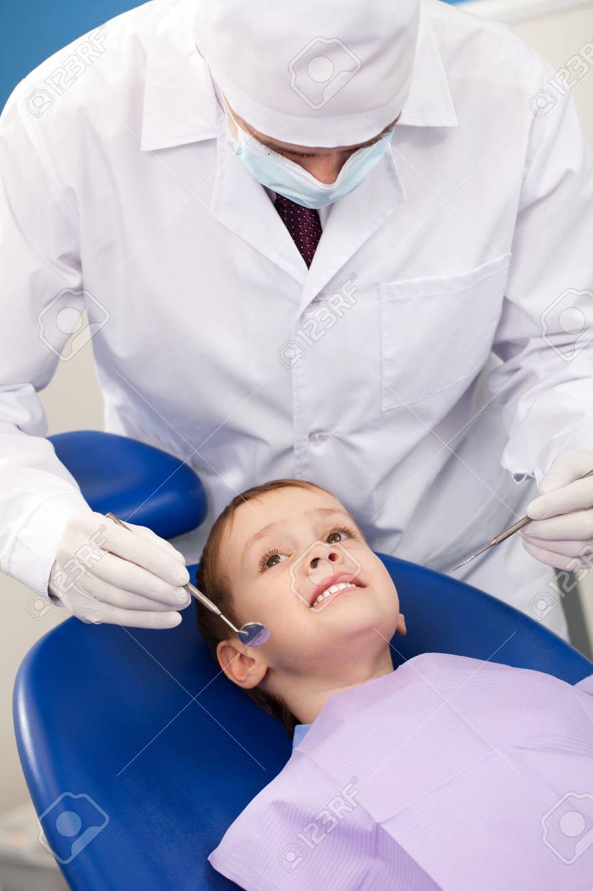 dentist treats tooth intern at the boy stock photo picture and dental intern