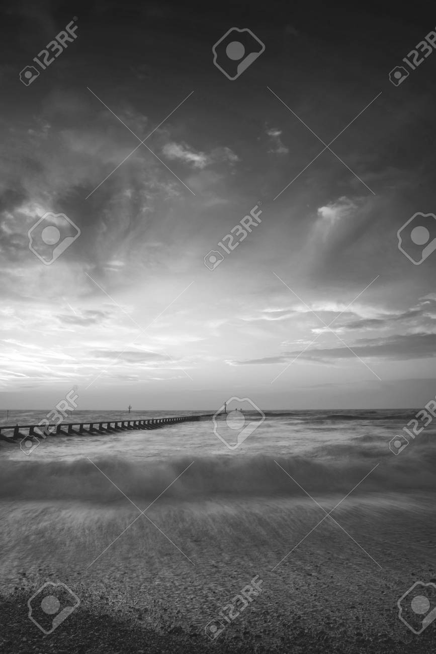 Beautiful moody black and white stormy landscape image of waves