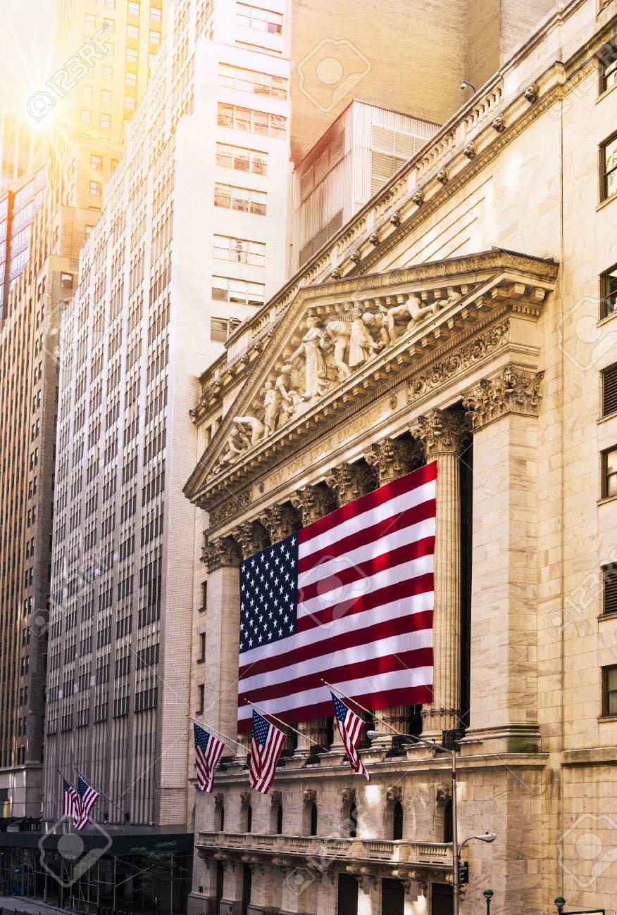 Famous Wall street and the building in New York, New York Stock Exchange with patriot flag - 44771958 Famous Wall street and the building in New York, New York Stock Exchange with patriot flag - 44771958