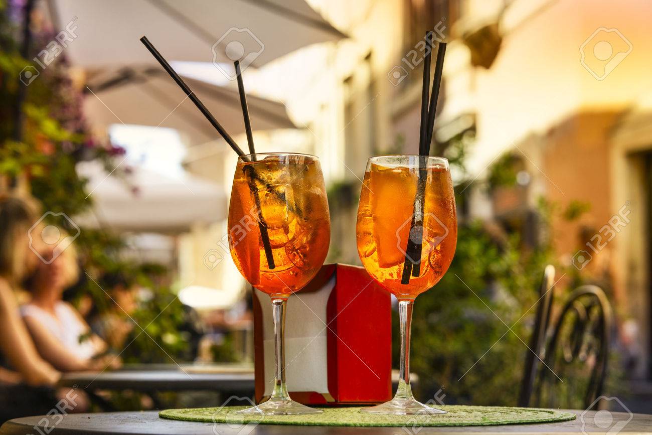 Aperol Spritz Cocktail. Alcoholic beverage based on table with ice cubes and oranges. - 65111043 Aperol Spritz Cocktail. Alcoholic beverage based on table with ice cubes and oranges. - 65111043