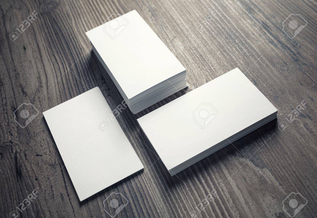 three piles of blank business cards on wood table background